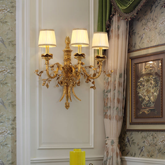 The French castle wall light installed on a light-colored wall with green curtains and a decorative painting.