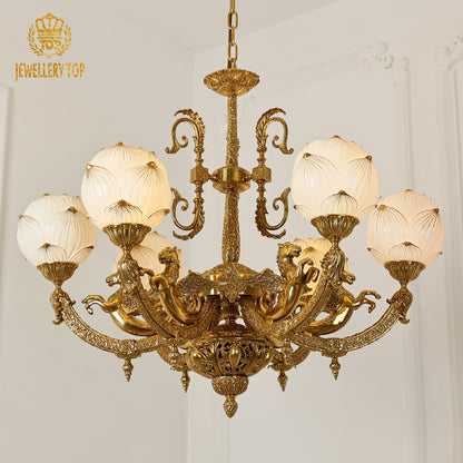 A luxury chandelier installed in a grand residence hallway with classic wall paneling and a decorative archway.