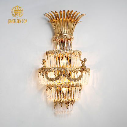 JEWELLERY TOP branded close-up of the golden brass sconce, highlighting intricate metalwork and glowing bulbs.