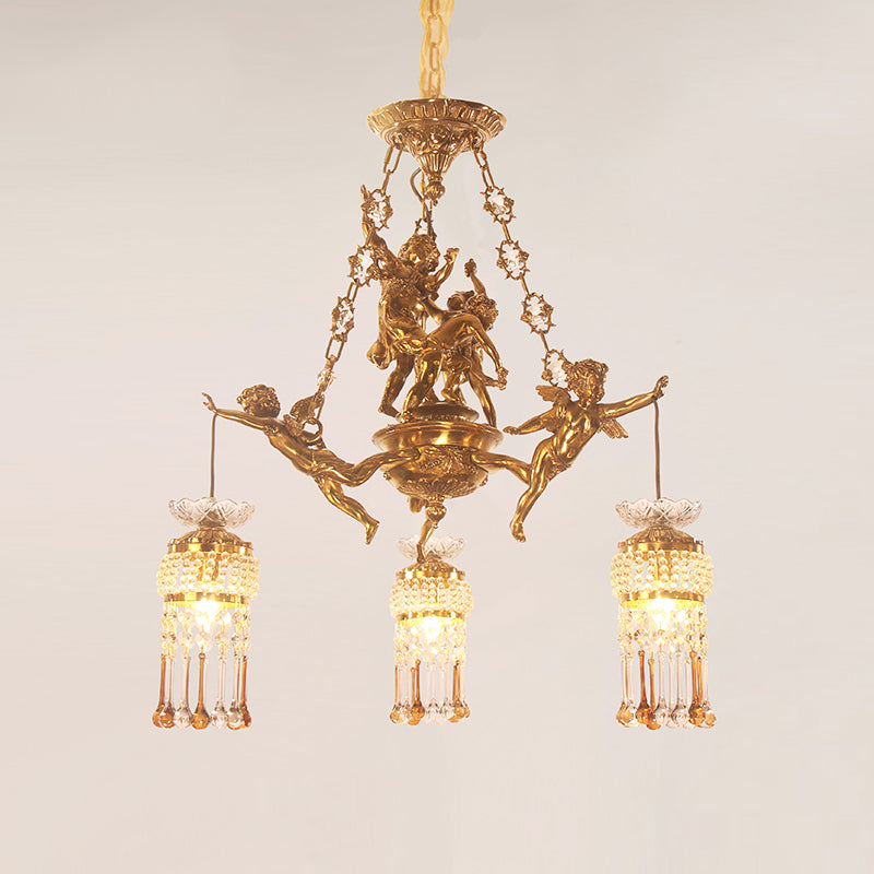 Close-up of a golden brass chandelier centerpiece with multiple playful cherub figurines.