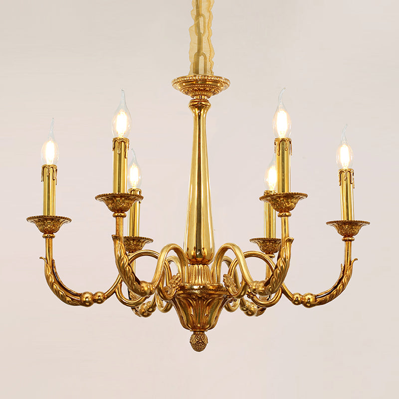 Close-up detail of a luxurious brass chandelier arm with textured finish and bulb.