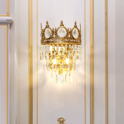 JEWELLERY TOP branded close-up of the crown wall light, highlighting the crystal-filled oval frames and brass details on white.