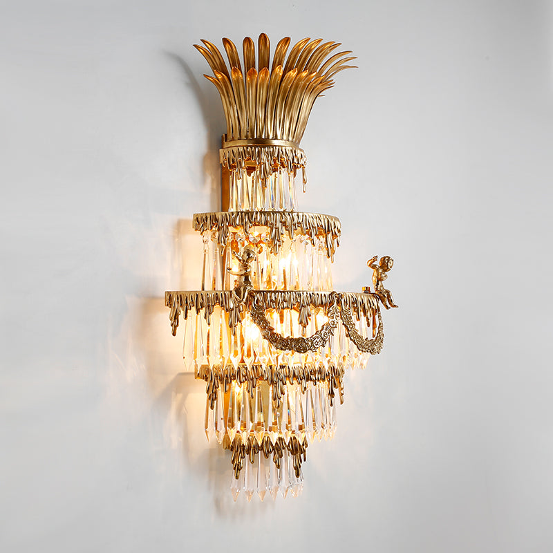 Detailed macro shot of the seated cherub figurine and the surrounding crystal bead curtains on the wall light.