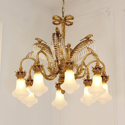 Close-up detail of the ornate brass palm frond and hanging crystal droplets on the chandelier.