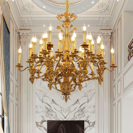 A grand Baroque-style brass chandelier installed in an opulent interior with marble walls and ornate ceiling.