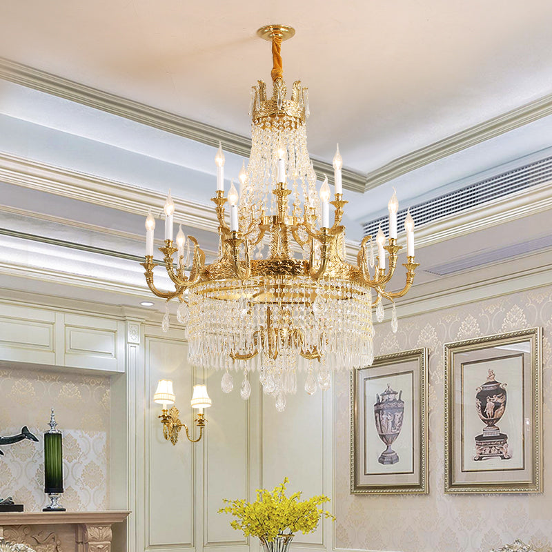 The large brass chandelier installed in an elegant room with artwork and decorative molding.