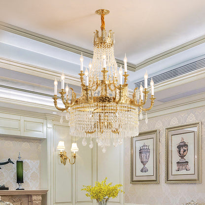 The large brass chandelier installed in an elegant room with artwork and decorative molding.