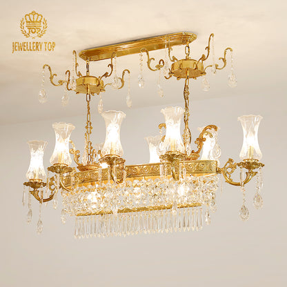 JEWELLERY TOP brand's rectangular crystal brass chandelier against a light wall.