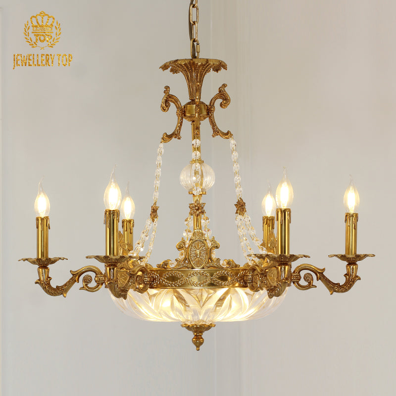 Front view of JEWELLERY TOP's golden brass chandelier with candle bulbs and a crystal centerpiece.