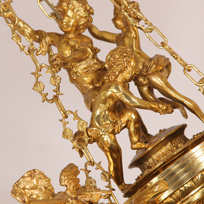 Macro detail of interconnected cherub sculptures and ornate brass scrollwork on the chandelier.