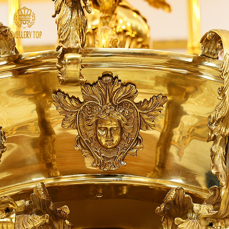 Detailed view of multiple ornate arms and candle bulbs on a golden luxury chandelier.
