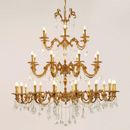 A luxury brass chandelier with multiple candle-style lights and sparkling crystal decorations.